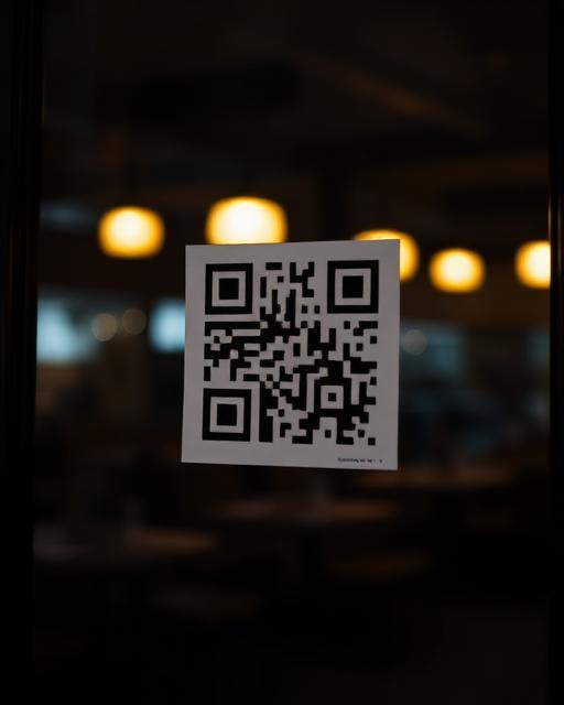 QR sticker on a bakery window at night
